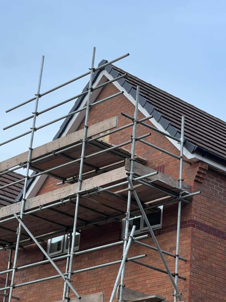 This is a photo of a roof which has just been repaired. There is a scaffold located at the gable end for access onto the roof. Works carried out by LJ Roofing Pewsham